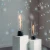 SPIN Air 1200 de Höfats, chimenea de bioetanol de sobremesa negra con diseño cilíndrico y llama giratoria decorativa.
