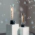 SPIN Air 900 de Höfats, chimenea de sobremesa en color negro con diseño de llama en espiral y cilindro de vidrio resistente al c